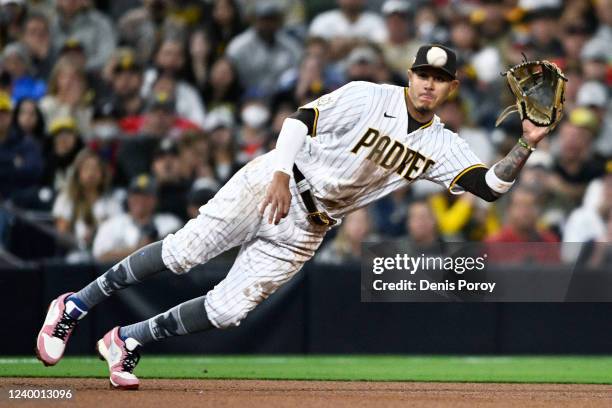 Manny Machado of the San Diego Padres makes a diving catch on a ball hit by Guillermo Heredia of the Atlanta Braves during the fifth inning of a...