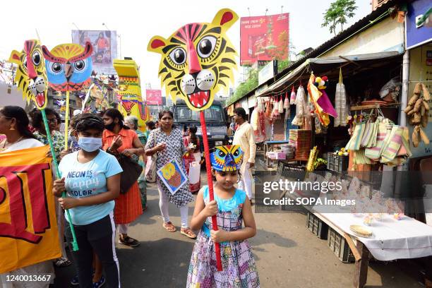 Bengalis hold masks to celebrate the first day of Bengali new Year. Bangladeshi people participate in a colorful parade to celebrate the first day of...