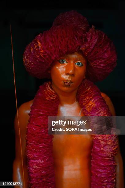 Devotee poses for a photo before the Lal Kach procession on the very last day of Bangla year. The Lal Kach festival is celebrated in the local...