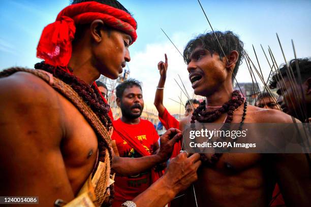 Hindu devotee is being pierced with sharp needles during Charak Puja Celebration. Charak Festival is one of the oldest Folk festivals as devotees...