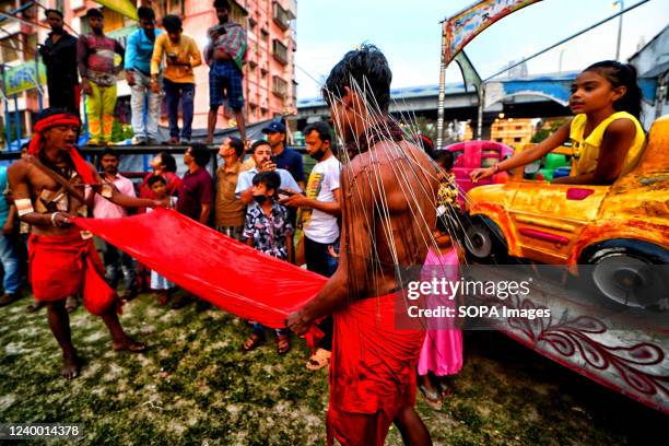 Hindu devotee seen showing his pierced body to the audience during Charak Puja Celebration. Charak Festival is one of the oldest Folk festivals as...