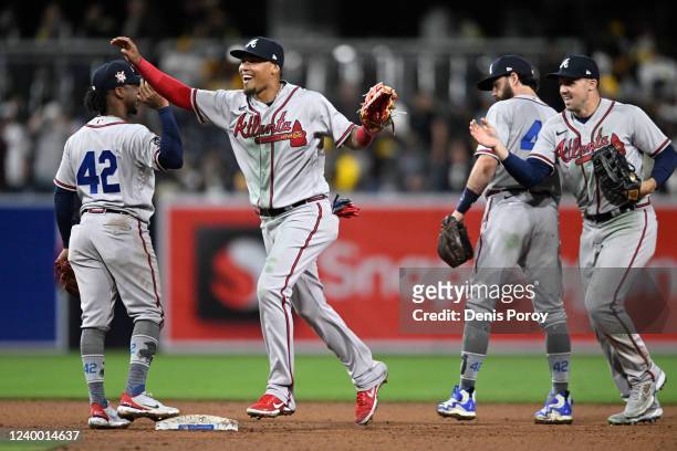 Orlando Arcia of the Atlanta Braves celebrates with teammates after a 5-2 win against the San Diego Padres at Petco Park on April 15, 2022 in San...