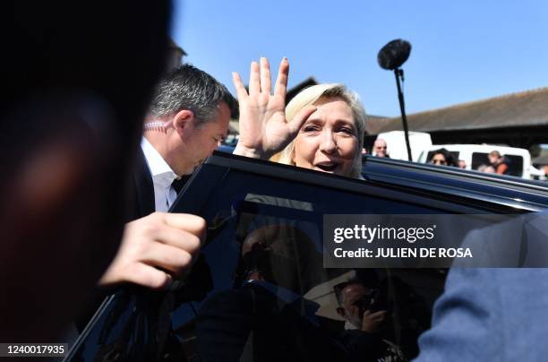 French far-right Rassemblement National party Member of Parliament and presidential candidate Marine Le Pen waves to onlookers during a campaign...