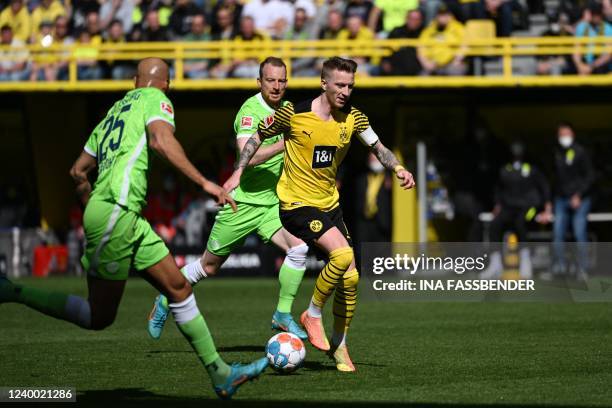 Wolfsburg's US defender John Anthony Brooks and Dortmund's German forward Marco Reus vie for the ball during the German first division Bundesliga...