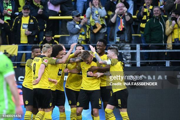 Dortmund's German defender Tom Alexander Rothe is celebrated by teammates for scoring the 1-0 during the German first division Bundesliga football...