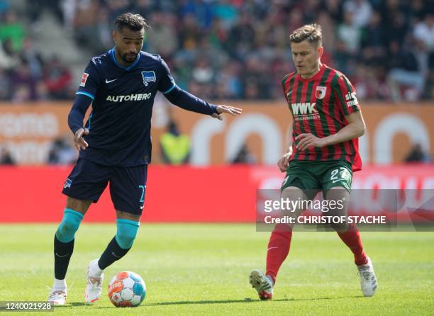 Hertha Berlin's Ghanaian midfielder Kevin-Prince Boateng and Augsburg's Icelandic forward Alfred Finnbogason vie for the ball during the German first...