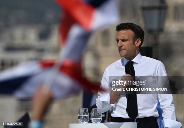 France's President and La Republique en Marche candidate for re-election Emmanuel Macron looks on during an election campaign meeting in Marseille,...