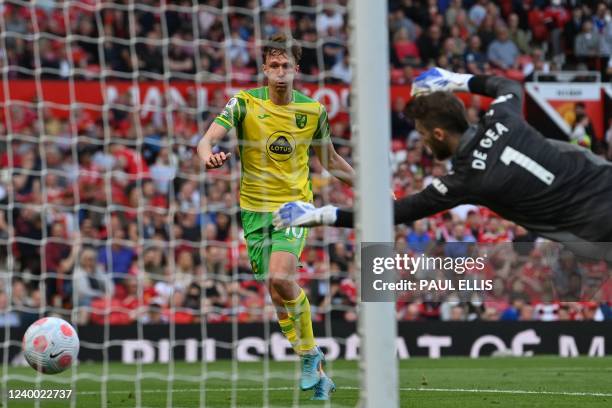 Norwich City's English midfielder Kieran Dowell scores their first goal during the English Premier League football match between Manchester United...
