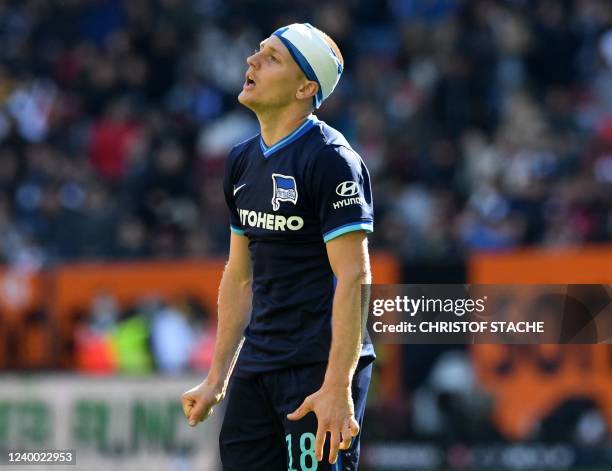 Hertha Berlin's Argentinian midfielder Santiago Ascacibar has a bandage on his head after an injury during the German first division Bundesliga match...