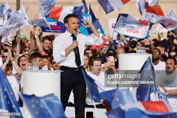 France's President and La Republique en Marche candidate for re-election Emmanuel Macron , surrounded by supporters, speaks during an election...