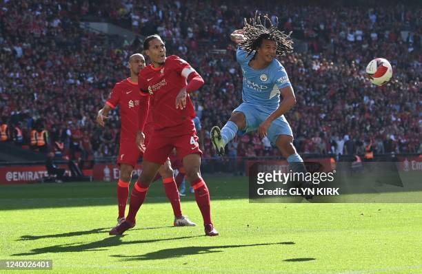 Manchester City's Dutch defender Nathan Ake heads the ball next to Liverpool's Dutch defender Virgil van Dijk during the English FA Cup semi-final...