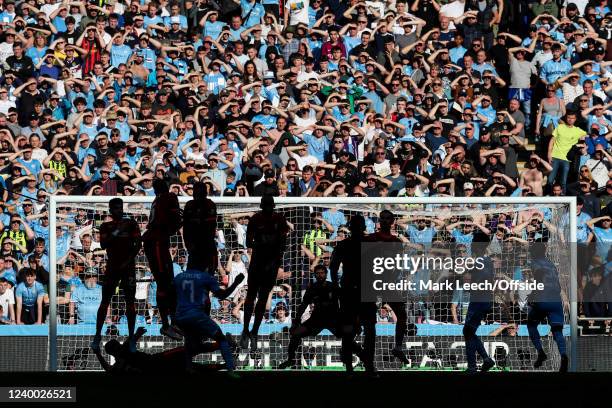Players are silhouetted against the Manchester City crowd as they hold their hands up to shield their eyes from the sun during The Emirates FA Cup...