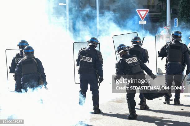 Police officers stand surrounded by tear gas, during a demonstration against racism, fascism and far-right in Nantes, western France, on April 16...