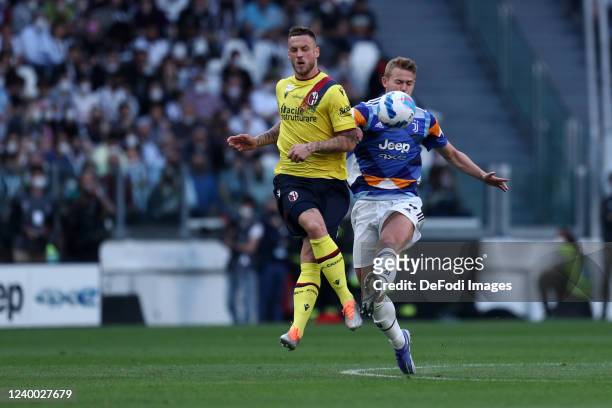 Matthijs de Ligt of Juventus FC and Marko Arnautovic of Bologna Fc battle for the ball during the Serie A match between Juventus and Bologna FC at...