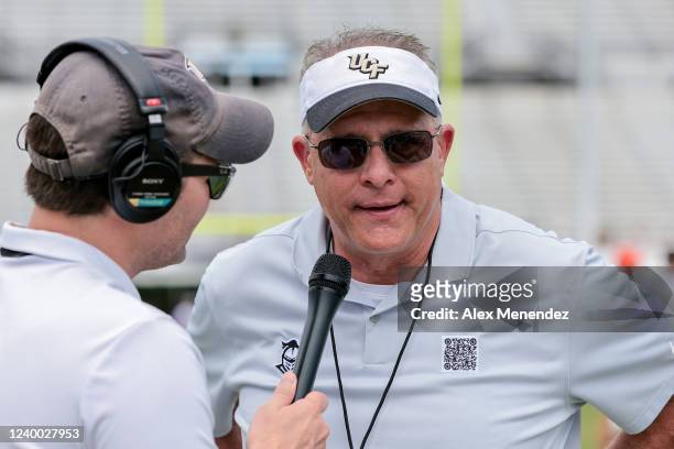 Knights head coach Gus Malzahn speaks with media after the UCF Spring Game at the Bounce House on April 16, 2022 in Orlando, Florida. The players are...