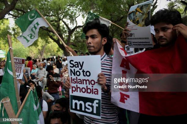Protestor holds a placard during a demonstration against rise in hate crimes and anti-Muslim violence in New Delhi, India on April 16, 2022.