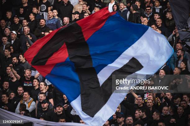 Partizan supporters wave a Serbian flag with the letter Z during the Serbian SuperLiga Play-Off match between Crvena Zvezda and Partizan Belgrade at...