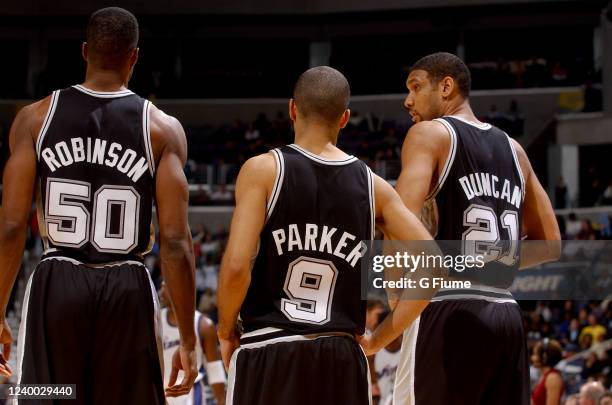 David Robinson,Tim Duncan, and Tony Parker of the San Antonio Spurs talk during the game against the Washington Wizards on December 31, 2002 at the...