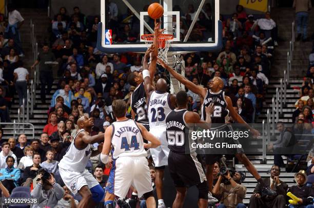 Tim Duncan of the San Antonio Spurs blocks a shot by Michael Jordan of the Washington Wizards on December 31, 2002 at the MCI Center in Washington...