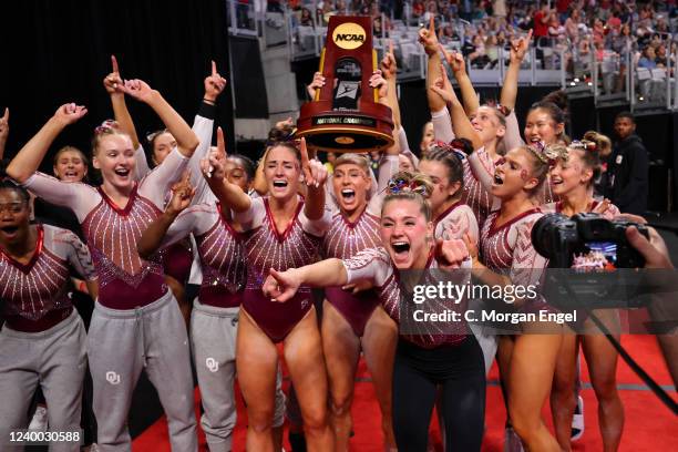 Olivia Trautman of the Oklahoma Sooners celebrates with the trophy after winning the Division I Womens Gymnastics Championship held at Dickies Arena...