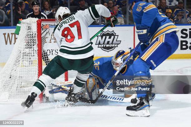 Ville Husso of the St. Louis Blues defends the net against Kirill Kaprizov of the Minnesota Wild at the Enterprise Center on April 16, 2022 in St....