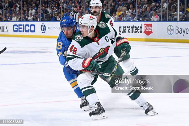 Pavel Buchnevich of the St. Louis Blues defends against Jared Spurgeon of the Minnesota Wild at the Enterprise Center on April 16, 2022 in St. Louis,...