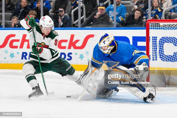 St. Louis Blues goaltender Ville Husso stops the inclose scoring attempt by Minnesota Wild left wing Kirill Kaprizov during a game between the...