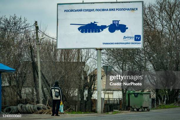 Man looks a ironic banner in Dnipro city saying: &quot;russian soldier, sowing campaign has already begun&quot;, in reference to the famous snapshots...