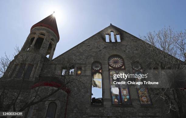 Damaged stained glass windows are illuminated by the sun at Antioch Missionary Baptist Church on Saturday, April 16 in Chicago. A fire destroyed the...