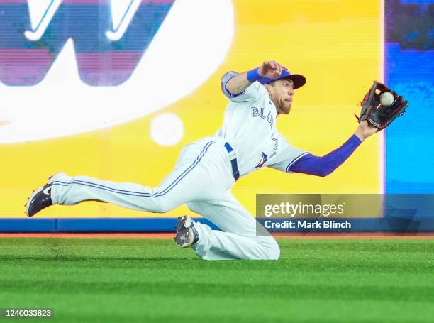 Bradley Zimmer of the Toronto Blue Jays makes a diving catch against the Oakland Athletics in the seventh inning during their MLB game at the Rogers...