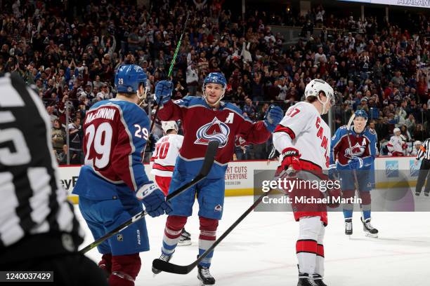 Nathan MacKinnon and Mikko Rantanen of the Colorado Avalanche celebrate a goal against the Carolina Hurricanes at Ball Arena on April 16, 2022 in...