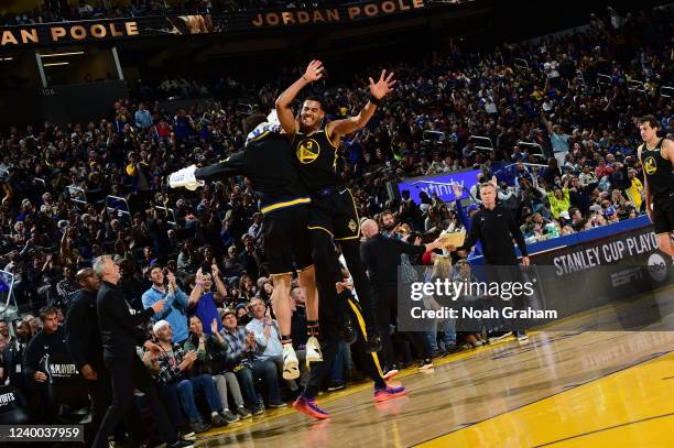 Klay Thompson of the Golden State Warriors and Jordan Poole high five against the Denver Nuggets during Round 1 Game 1 of the 2022 NBA Playoffs on...
