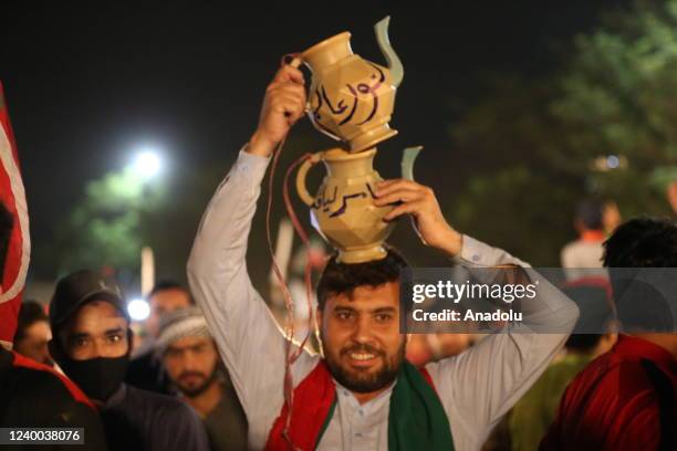 Supporters of Pakistan Tehreek-e-Insaf party watch PTI public rally on a giant screen in Islamaad Pakistan on April 16, 2022. Imran Khan made a...