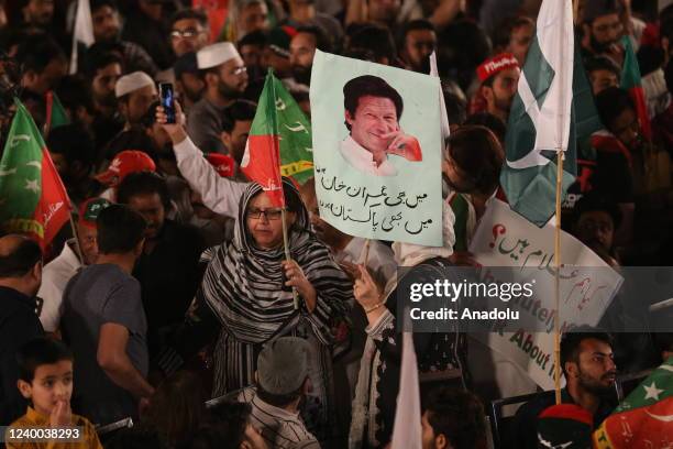Supporters of Pakistan Tehreek-e-Insaf party watch PTI public rally on a giant screen in Islamaad Pakistan on April 16, 2022. Imran Khan made a...
