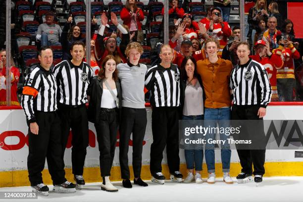 Referee Brad Meier, family and colleagues celebrate his last NHL game between the Calgary Flames and the Arizona Coyotes at Scotiabank Saddledome on...