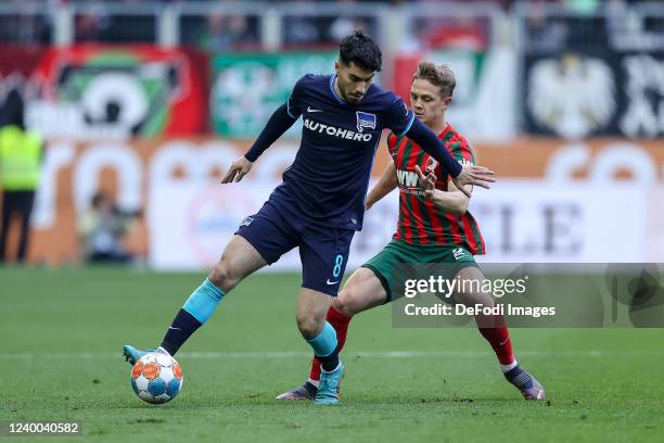 Suat Serdar of Hertha BSC and Robert Gumny of FC Augsburg battle for the ball during the Bundesliga match between FC Augsburg and Hertha BSC at...