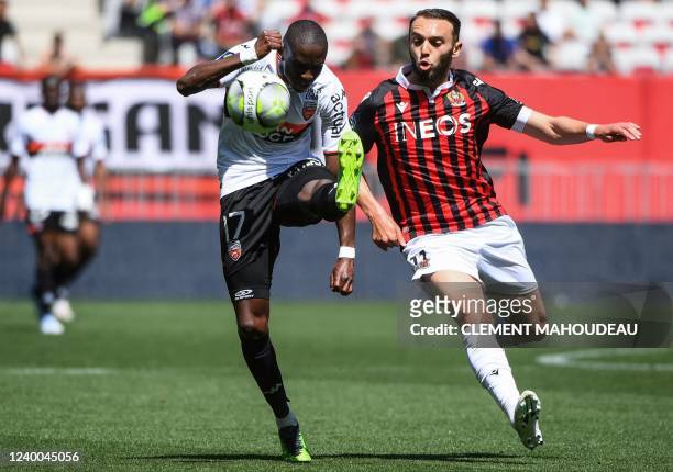 Nice's French forward Amine Gouiri fights for the ball with Lorient's French defender Houboulang Mendes during the French L1 football match between...