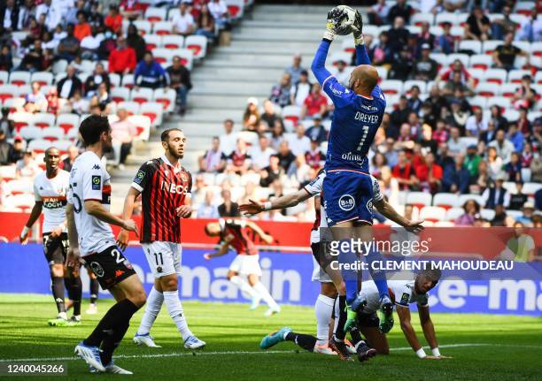 Lorient's French goalkeeper Matthieu Dreyer jumps to catch the ball during the French L1 football match between OGC Nice and FC Lorient at The...