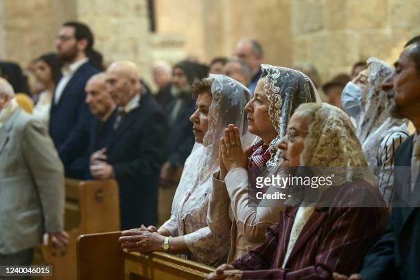 Syrian Christians attend Easter Sunday mass at the Fourty Martyrs Armenian church in the northern city of Aleppo on April 17, 2022.