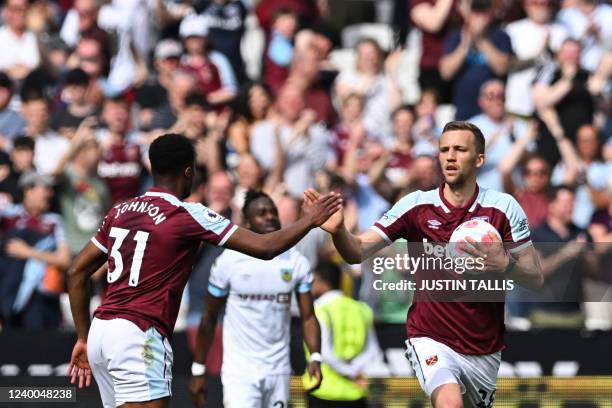 West Ham United's Czech midfielder Tomas Soucek celebrates with West Ham United's English defender Ben Johnson after scoring his team first goal...