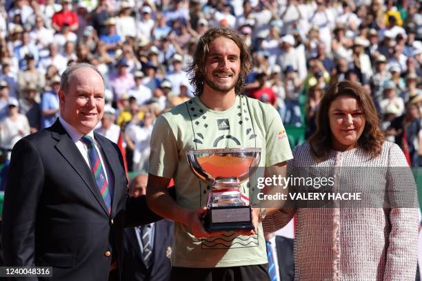 Greece's Stefanos Tsitsipas celebrates with his trophy next to Prince Albert II of Monaco and Melanie-Antoinette de Massy President of the Monegasque...