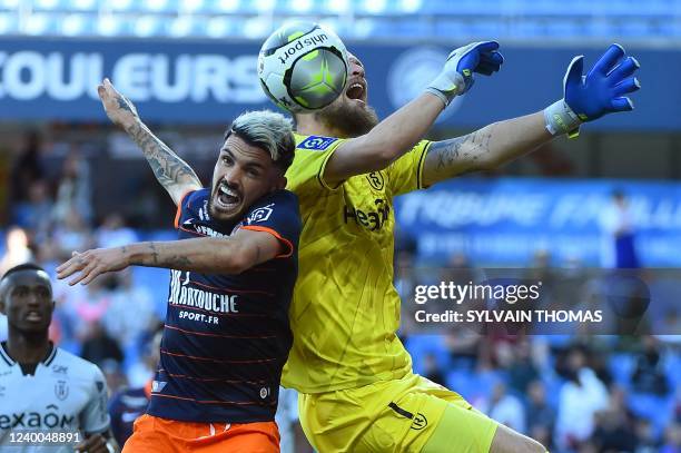 Reims' Serbian goalkeeper Predrag Rajkovic fights for the ball with Montpellier's French midfielder Remy Cabella during the French L1 football match...