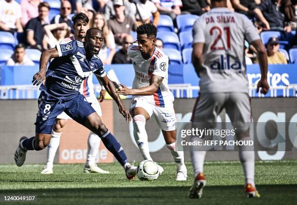 Lyons Brazilian defender Tete fights for the ball with Bordeaux Cameroonian midfielder Junior Onana during the French L1 football match between...