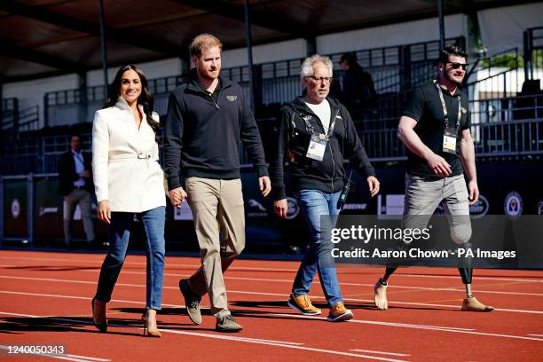 The Duke and Duchess of Sussex, with Invictus Games trustee and paralympian Dave Henson , attending the Invictus Games athletics events in the...