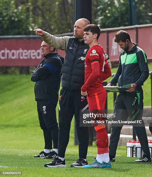 Layton Stewart of Liverpool takes instruction from U23 manager Barry Lewtas before he takes the field to make his injury comeback during the PL2 game...