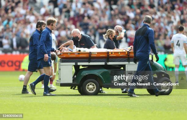 Burnley's Ashley Westwood is stretchered off during the Premier League match between West Ham United and Burnley at London Stadium on April 17, 2022...