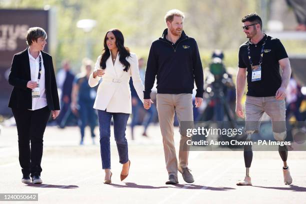 The Duke and Duchess of Sussex, with Invictus Games trustee and paralympian Dave Henson , attending the Invictus Games athletics events in the...