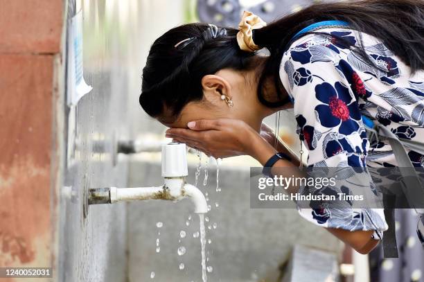 Visitor washes their face on a hot summer day near Rajghat, on April 17, 2022 in New Delhi, India.