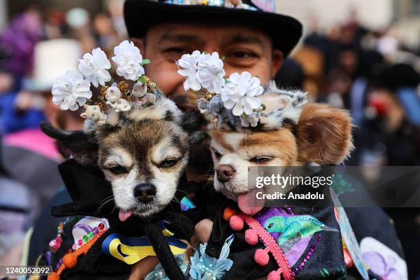 People participate with colorful costumes and hats at the annual Easter Parade and Bonnet Festival outside of St. Patrick's Cathedral in New York...