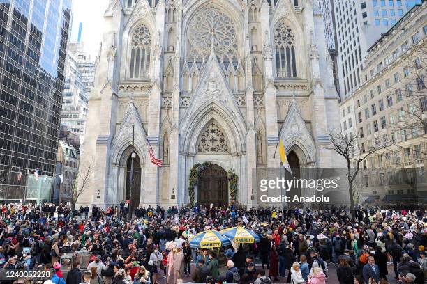 People participate with colorful costumes and hats at the annual Easter Parade and Bonnet Festival outside of St. Patrick's Cathedral in New York...